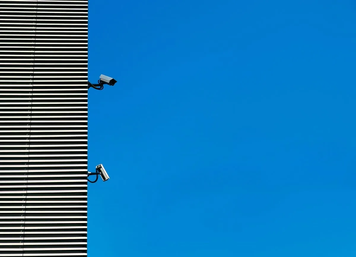 Security camera mounted on building with sky in the background